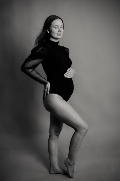 stehende schwangere Frau, Foto in schwarz-weiss